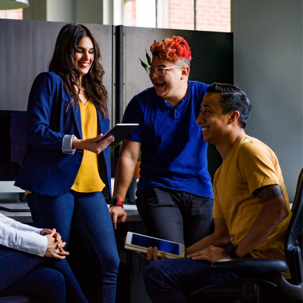 Students talking and smiling while holding tablets